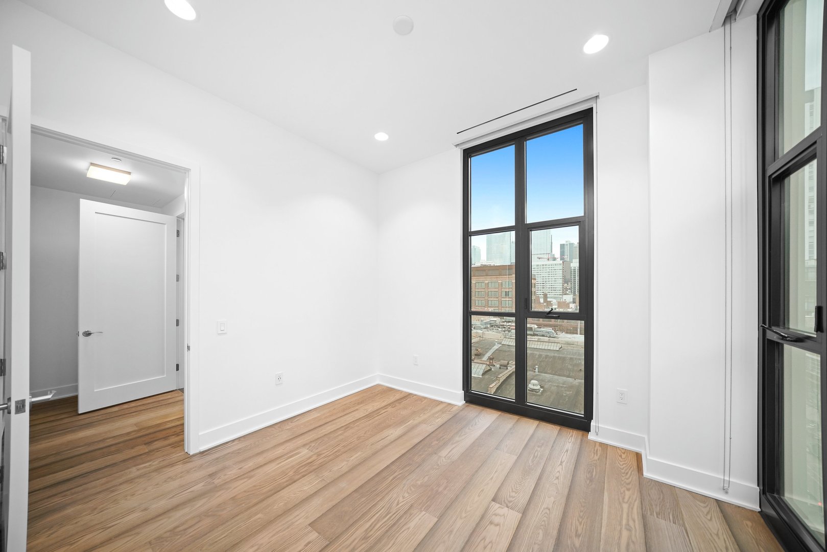 900 West Washington Boulevard, Unit 504 Chicago, IL 60607 - Photo 24 of 28 wooden floor in an empty room with a window