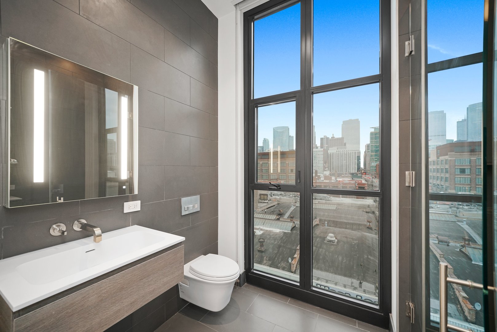 900 West Washington Boulevard, Unit 504 Chicago, IL 60607 - Photo 26 of 28 a bathroom with a double vanity sink toilet and next to a window