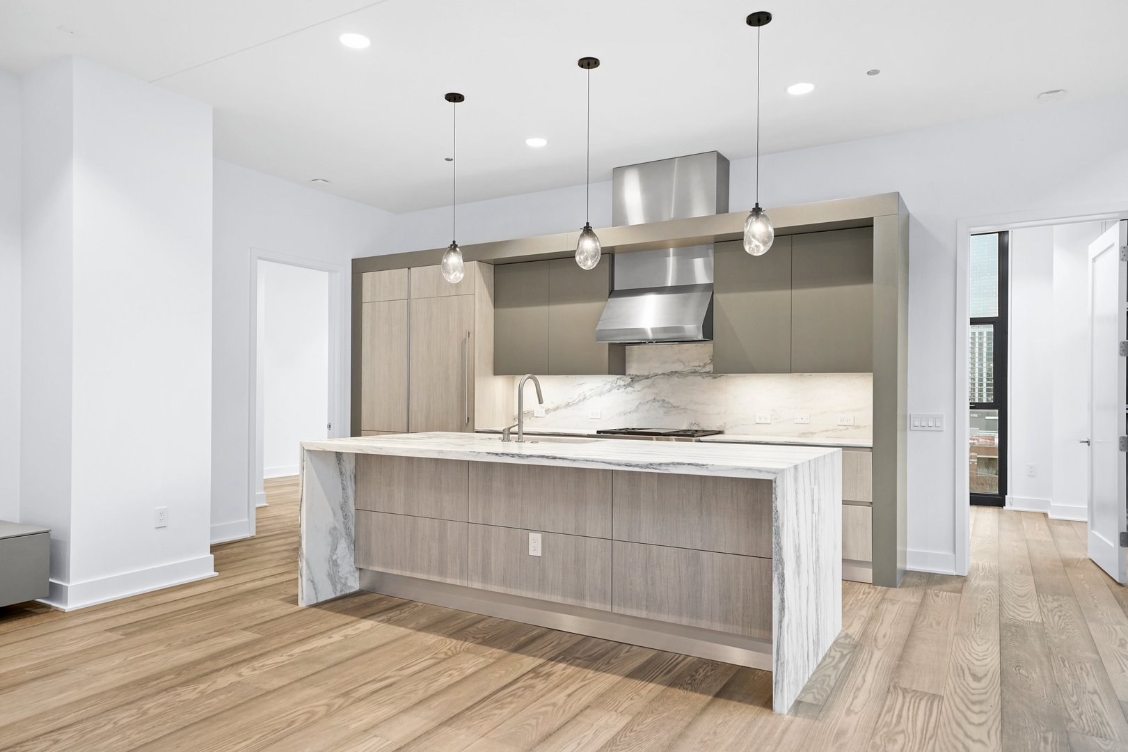 900 West Washington Boulevard, Unit 504 Chicago, IL 60607 - Photo 6 of 28 a kitchen with kitchen island a sink stainless steel appliances and cabinets