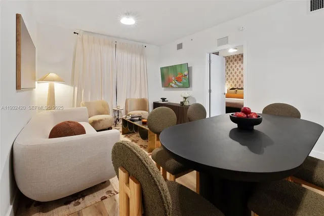 a living room with furniture a window and a lamp