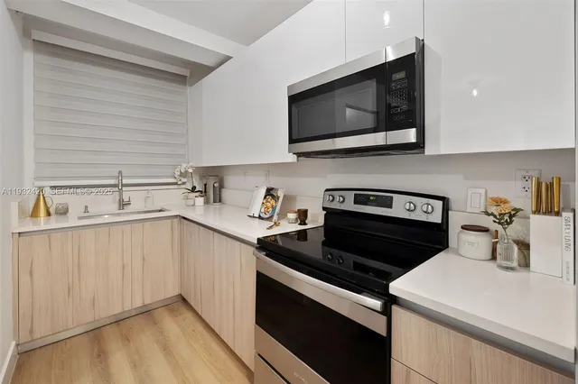a kitchen with a sink stove and microwave