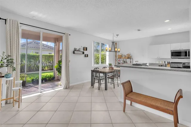 a kitchen with a refrigerator sink and cabinets