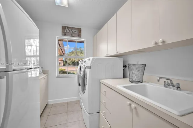 a living room with furniture a window and a chandelier