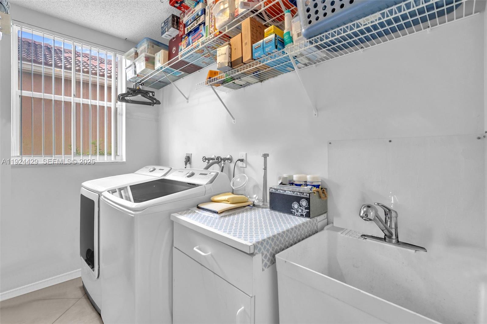 1058 Tupelo Way Weston, FL 33327 - Photo 37 of 43 a utility room with sink dryer and washer
