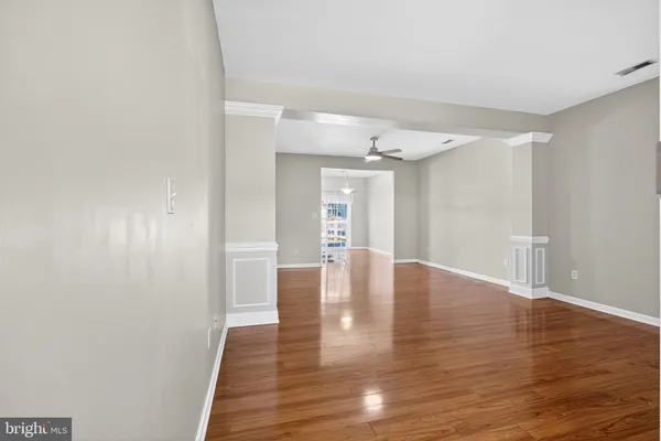 a kitchen with stainless steel appliances a refrigerator and wooden floor