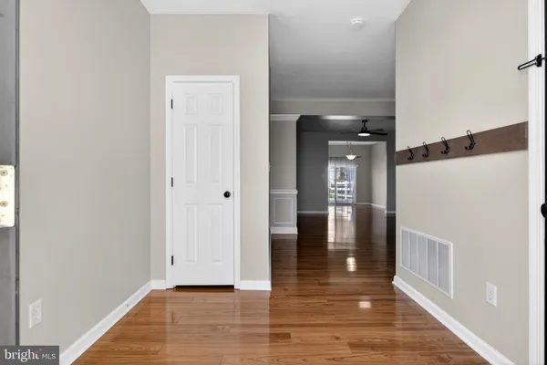 a view of empty room with wooden floor