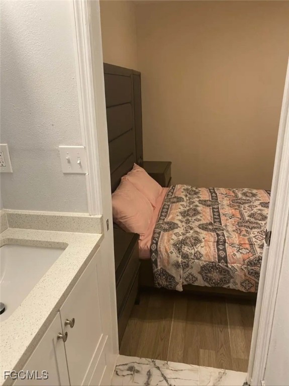 5230 32nd Avenue Southwest Naples, FL 34116 - Photo 11 of 11 a bedroom with a bed and a cabinets