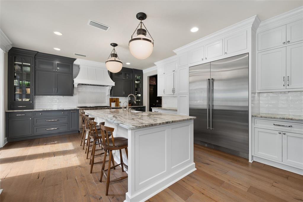 623 Southwest 93rd Street Gainesville, FL 32607 - Photo 22 of 100 a kitchen with kitchen island a counter top space a sink stainless steel appliances and cabinets