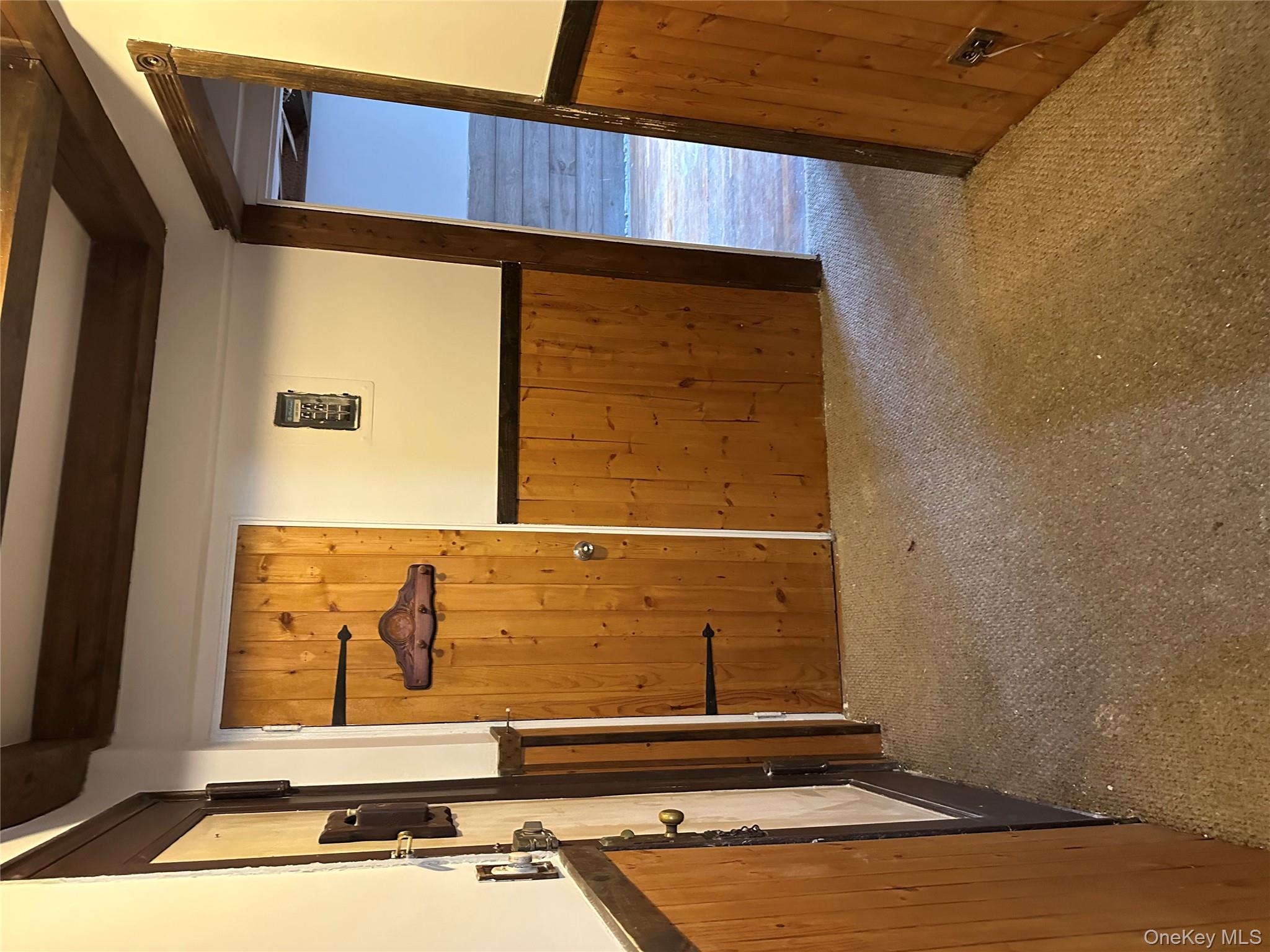 83-25 98th Street, Unit 4T Queens, NY 11421 - Photo 4 of 10 a view of an empty room with wooden floor and a window
