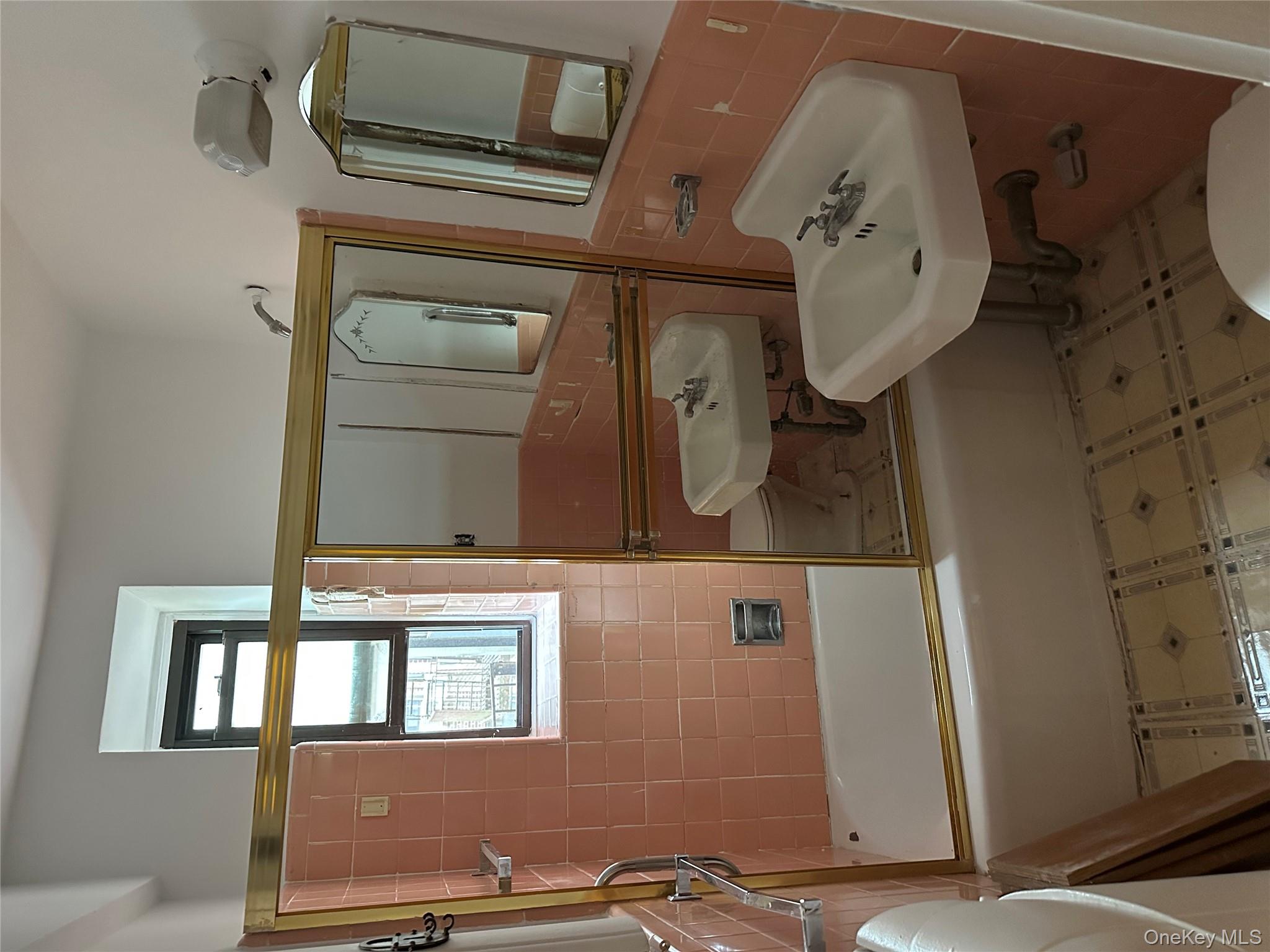 83-25 98th Street, Unit 4T Queens, NY 11421 - Photo 5 of 10 a bathroom with a sink and a bathtub