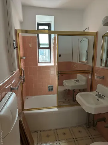 a bathroom with a sink mirror toilet and bathtub