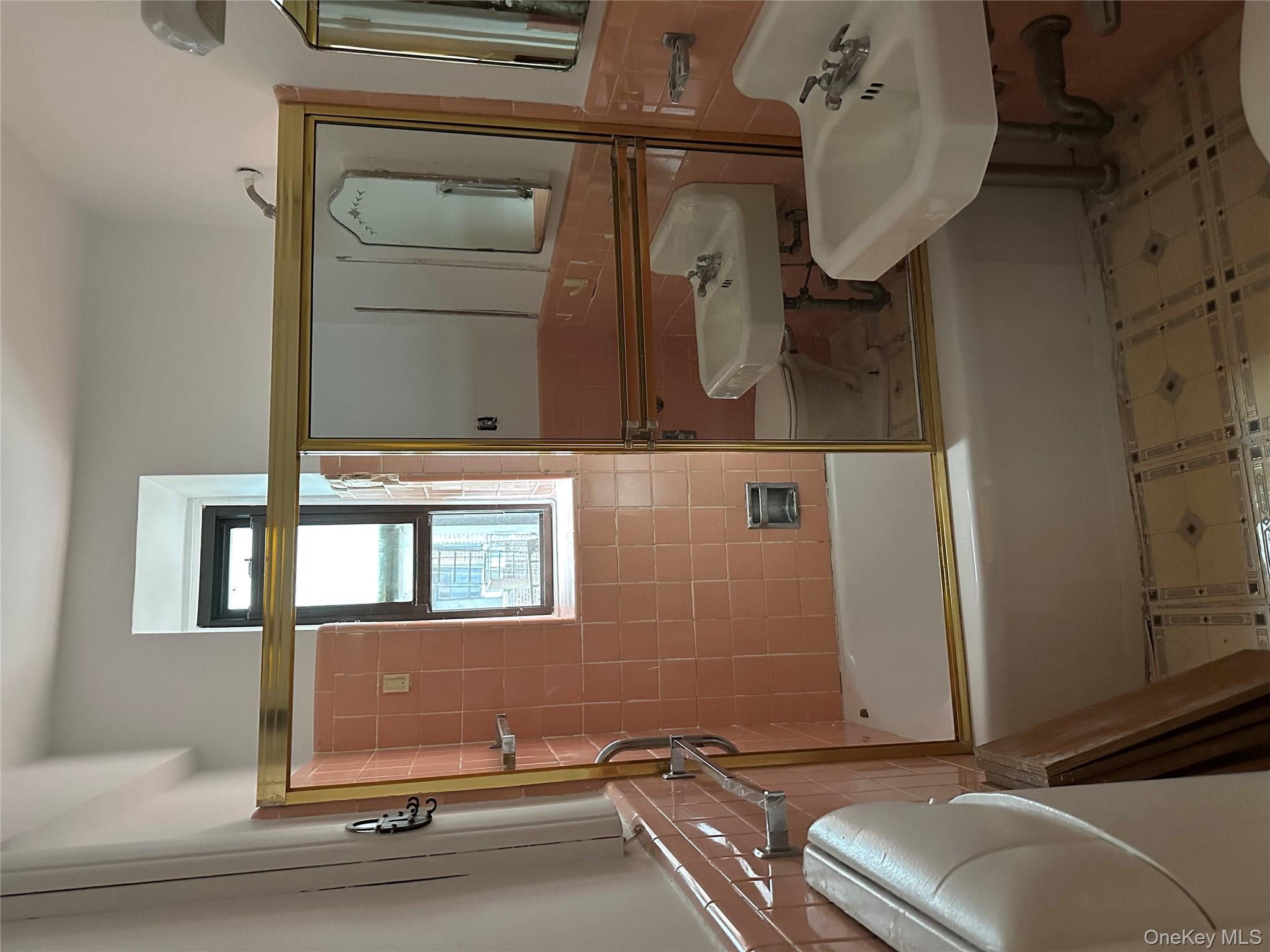 83-25 98th Street, Unit 4T Queens, NY 11421 - Photo 10 of 10 a bathroom with a sink mirror toilet and bathtub