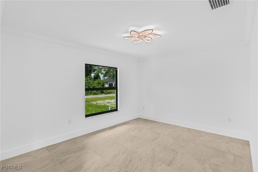 3310 3rd Street Southwest Lehigh Acres, FL 33976 - Photo 12 of 23 an empty room with a window