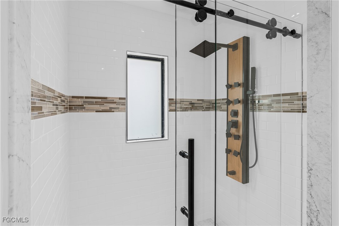 3310 3rd Street Southwest Lehigh Acres, FL 33976 - Photo 16 of 23 a bathroom with a shower and a shower