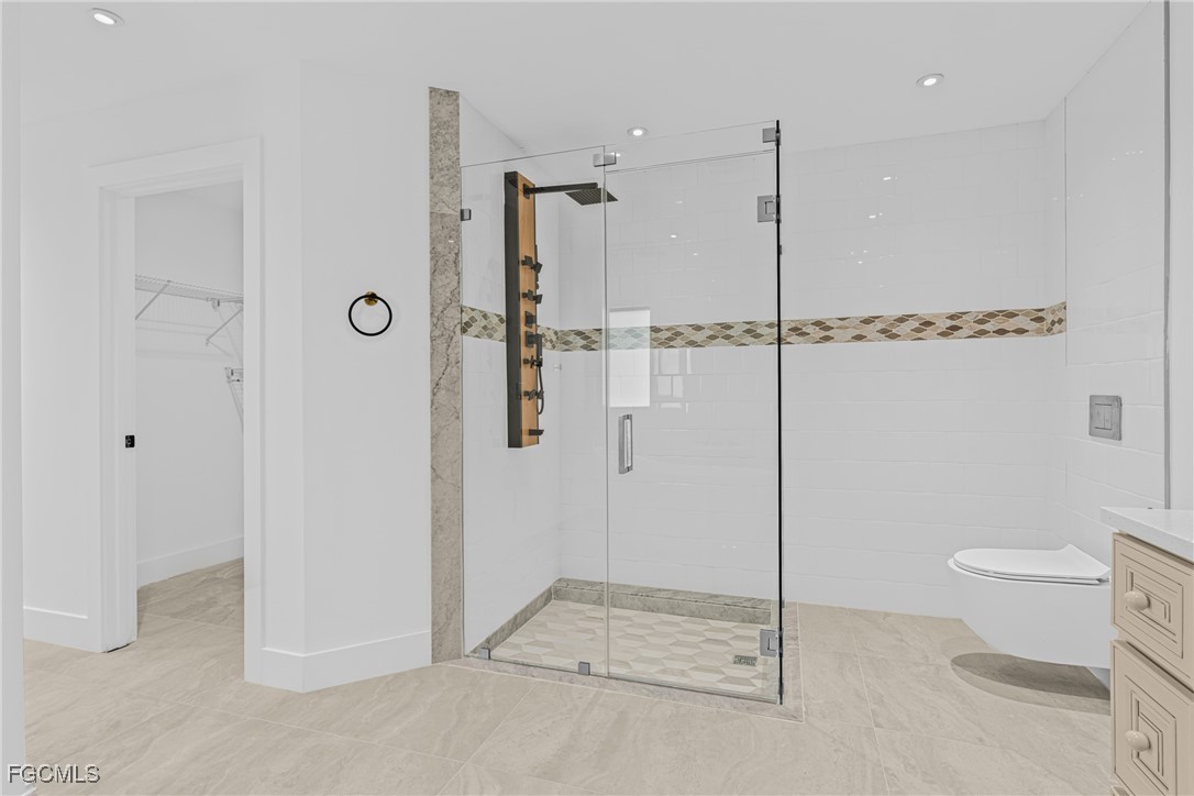 3310 3rd Street Southwest Lehigh Acres, FL 33976 - Photo 18 of 23 a bathroom with a shower and toilet