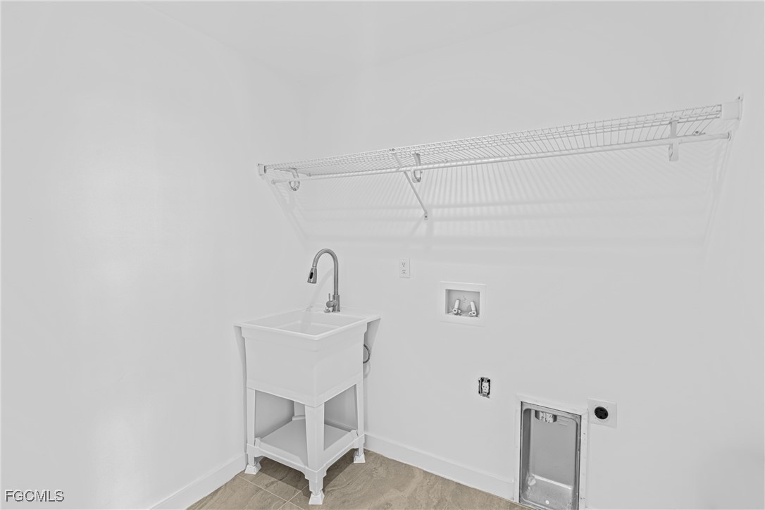 3310 3rd Street Southwest Lehigh Acres, FL 33976 - Photo 20 of 23 a bathroom with a sink a mirror and a shower