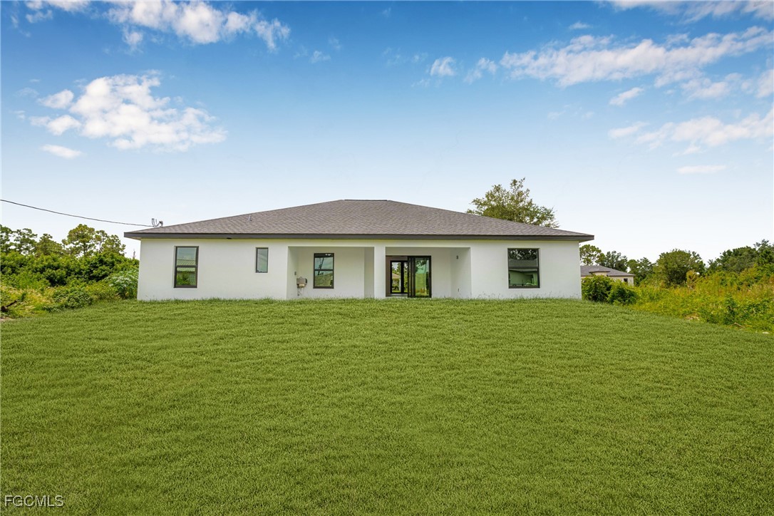 3310 3rd Street Southwest Lehigh Acres, FL 33976 - Photo 23 of 23 a front view of a house with a garden