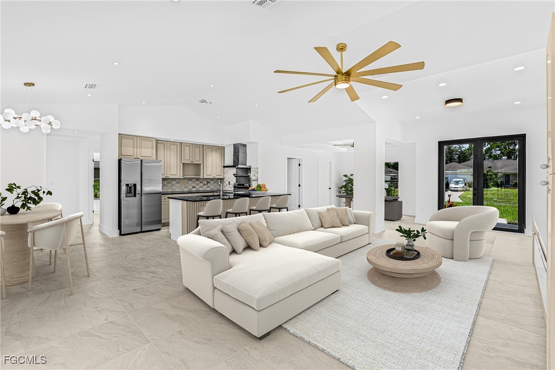 3310 3rd Street Southwest Lehigh Acres, FL 33976 - Photo 4 of 23 a living room with furniture white walls and kitchen view