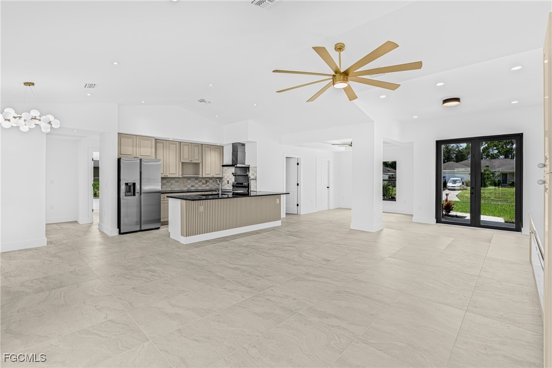 3310 3rd Street Southwest Lehigh Acres, FL 33976 - Photo 5 of 23 a view of a kitchen with a sink and a refrigerator