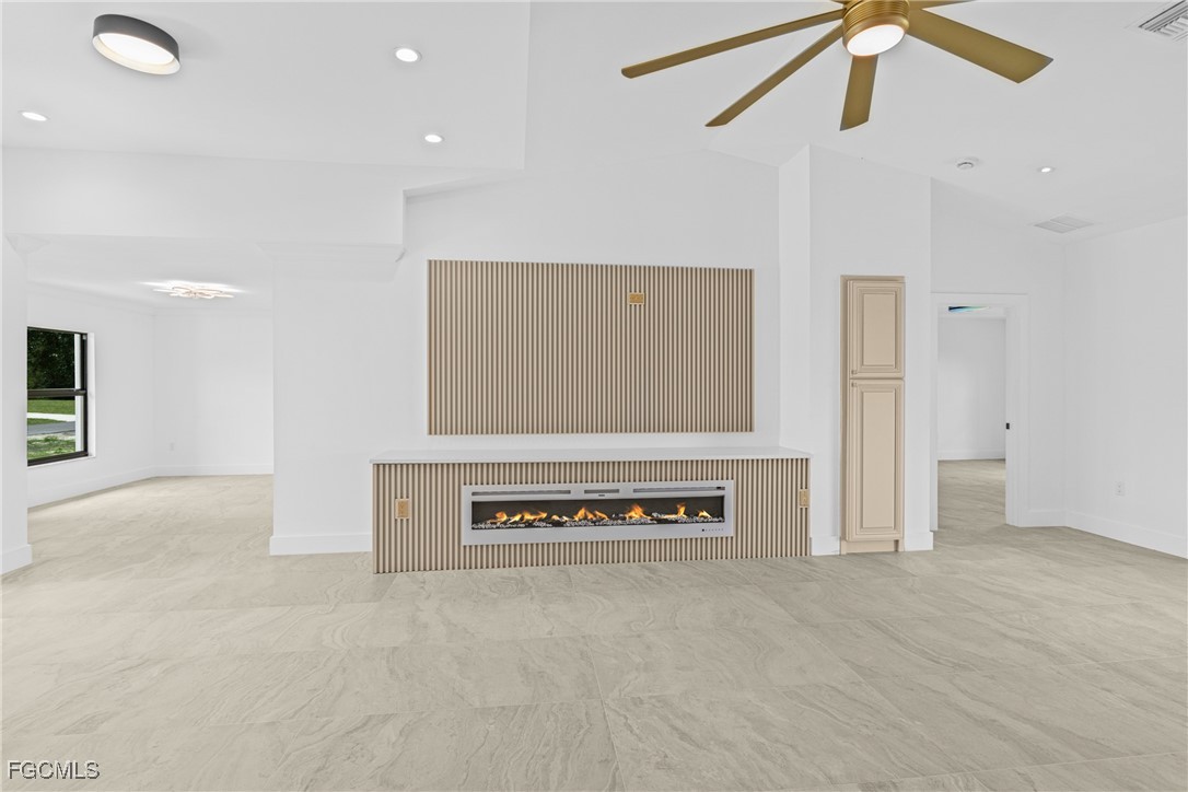 3310 3rd Street Southwest Lehigh Acres, FL 33976 - Photo 6 of 23 a view of an empty room with wooden floor