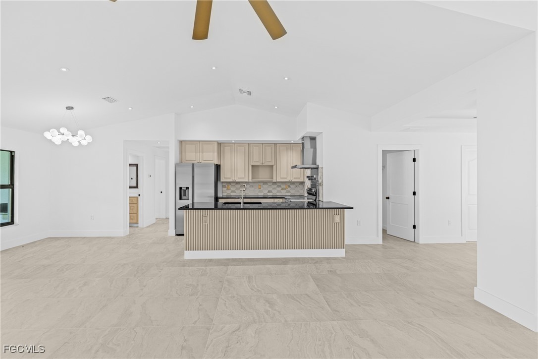 3310 3rd Street Southwest Lehigh Acres, FL 33976 - Photo 7 of 23 a view of kitchen with refrigerator and window