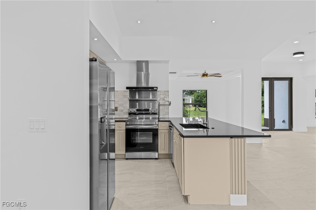 3310 3rd Street Southwest Lehigh Acres, FL 33976 - Photo 8 of 23 a kitchen with stainless steel appliances granite countertop a stove a sink and a refrigerator