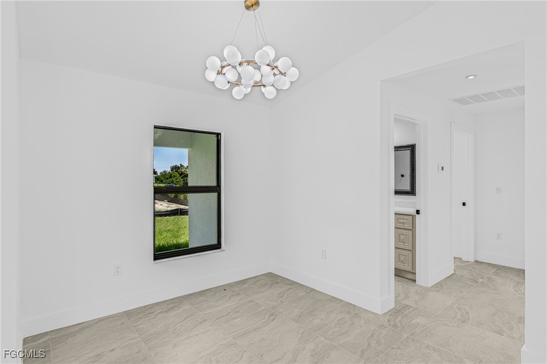 3310 3rd Street Southwest Lehigh Acres, FL 33976 - Photo 10 of 23 an empty room with windows and entrance
