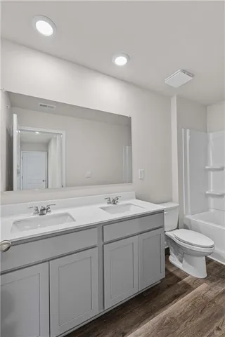 a bathroom with a toilet a sink and bathtub