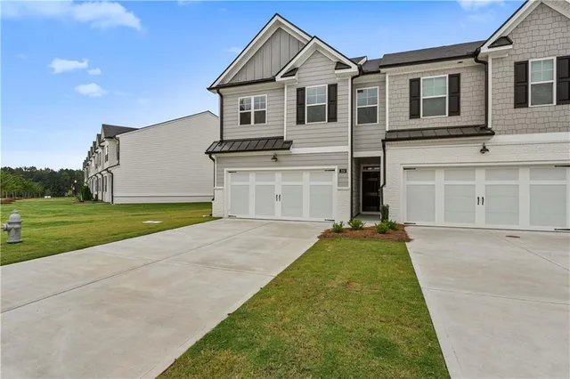 a view of a house with a yard and a garage