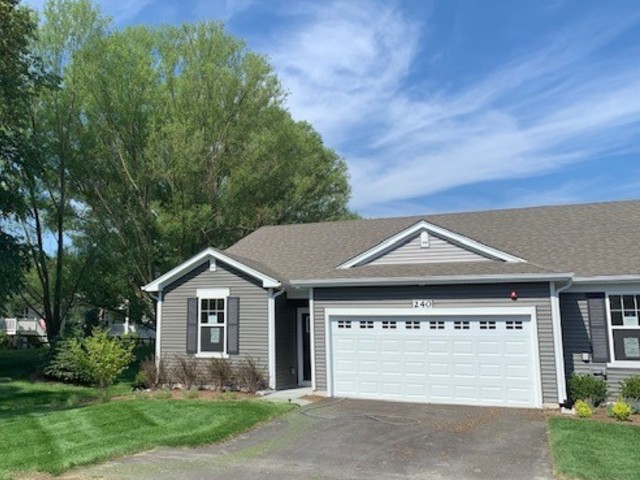 929 Darwin Street North Aurora, IL 60542 - Photo 2 of 42 a front view of a house with a yard and garage