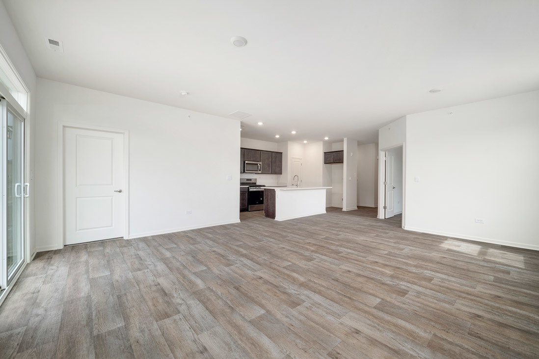 929 Darwin Street North Aurora, IL 60542 - Photo 9 of 42 a view of empty room with wooden floor and kitchen