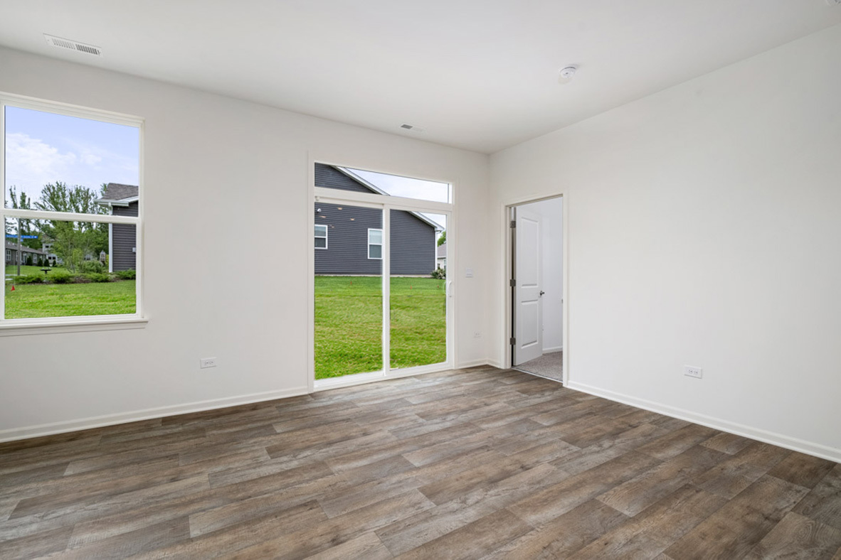 929 Darwin Street North Aurora, IL 60542 - Photo 10 of 42 a view of an empty room with window and wooden floor