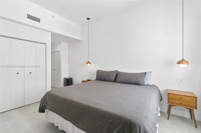 a bedroom with a bed and a chair