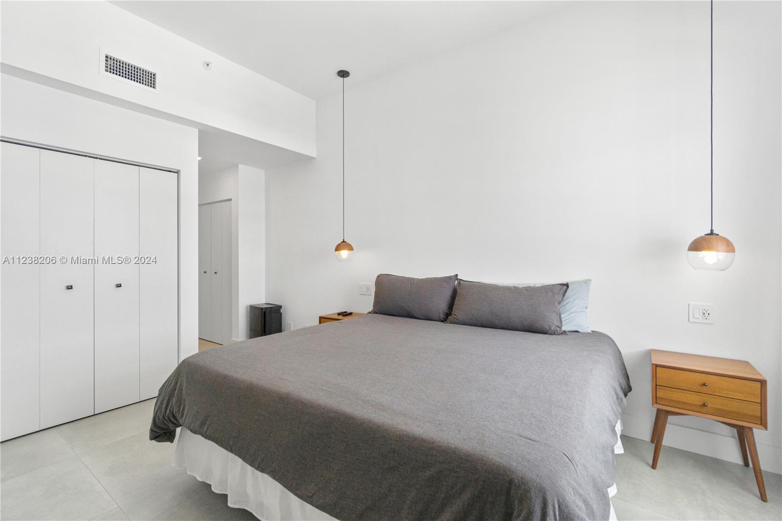 100 Lincoln Road, Unit 1608 Miami Beach, FL 33139 - Photo 15 of 22 a bedroom with a bed and a chair