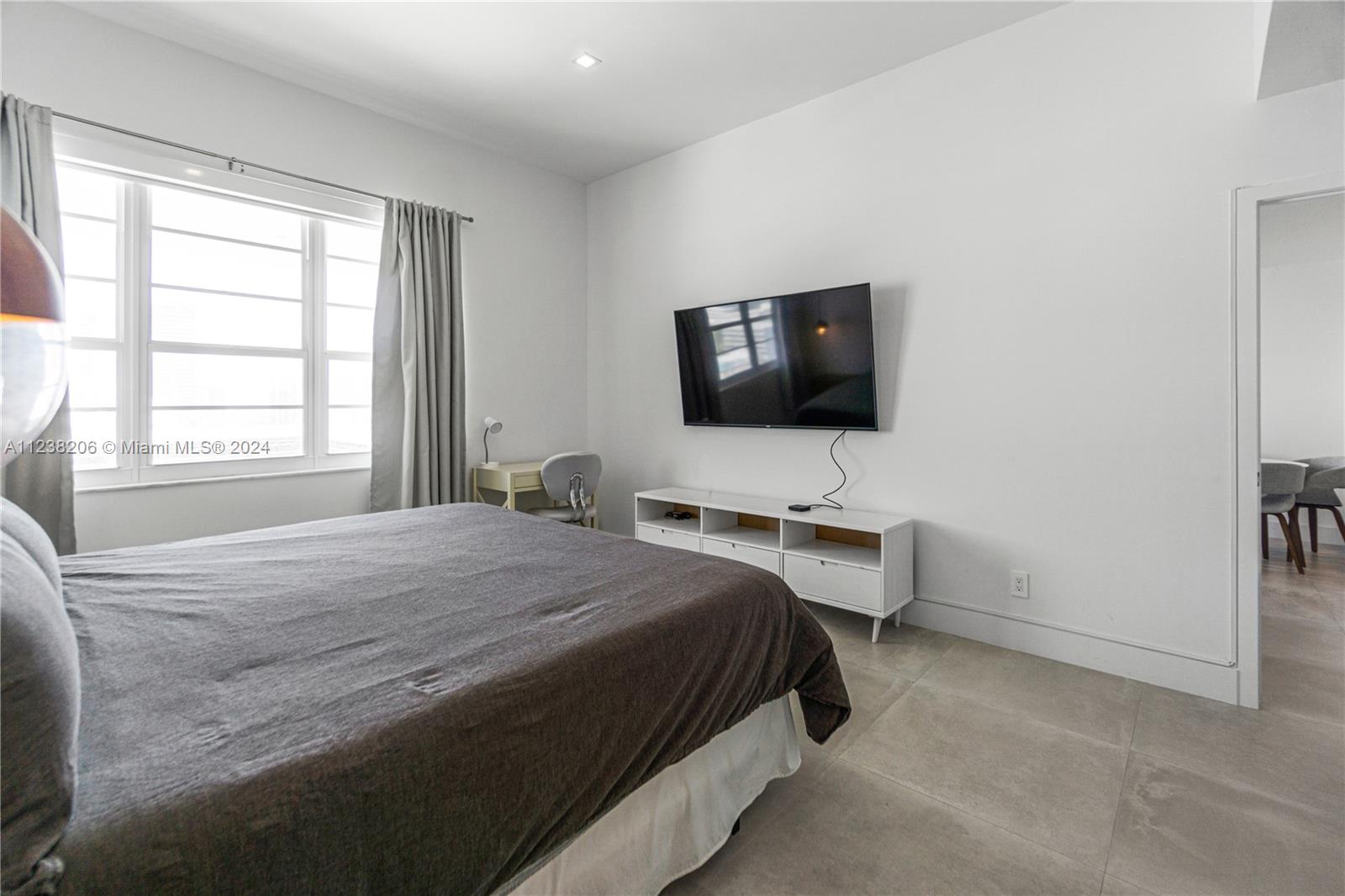 100 Lincoln Road, Unit 1608 Miami Beach, FL 33139 - Photo 17 of 22 a bedroom with a bed and a flat screen tv