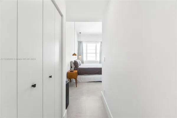 a hallway with sliding door and couch