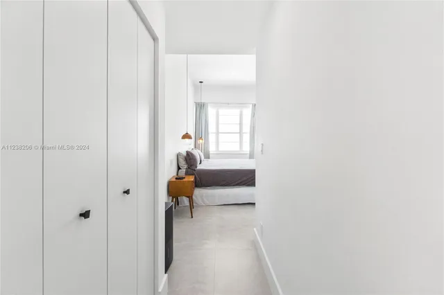 a hallway with sliding door and couch