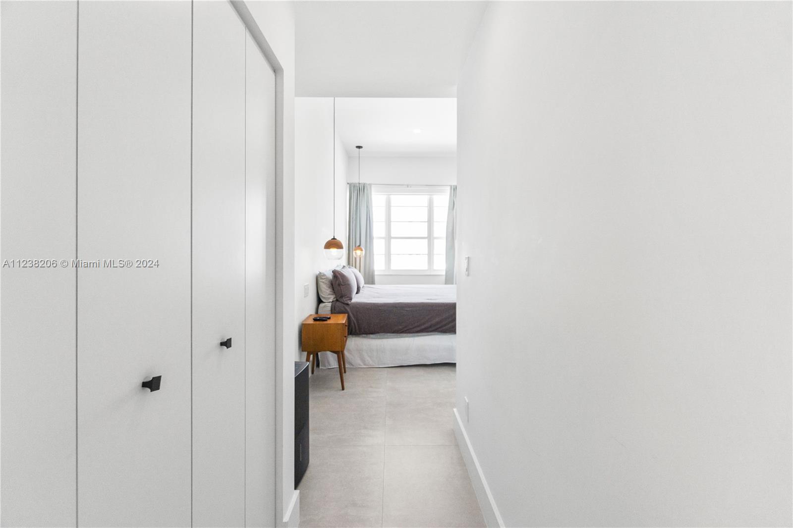 100 Lincoln Road, Unit 1608 Miami Beach, FL 33139 - Photo 18 of 22 a hallway with sliding door and couch