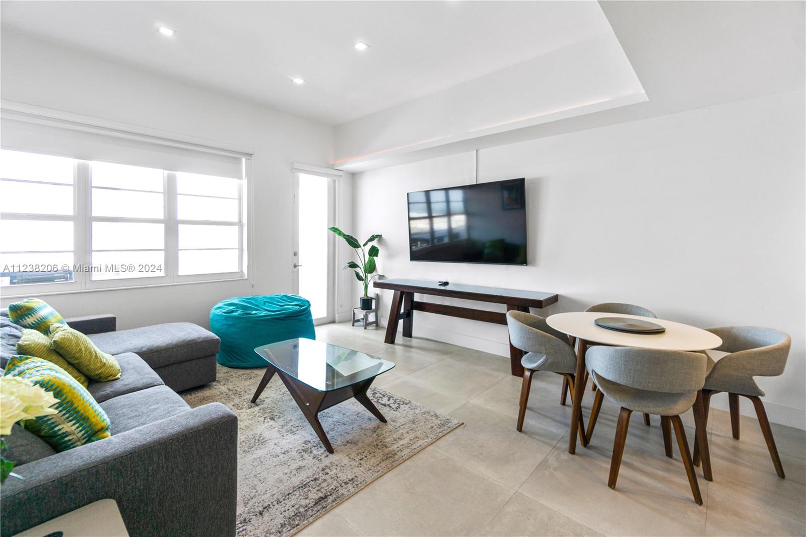 100 Lincoln Road, Unit 1608 Miami Beach, FL 33139 - Photo 2 of 22 a living room with furniture and a flat screen tv