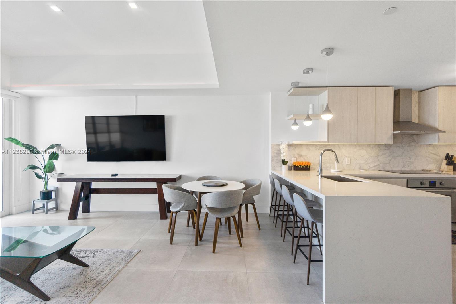 100 Lincoln Road, Unit 1608 Miami Beach, FL 33139 - Photo 4 of 22 a view of a dining room with furniture and wooden floor