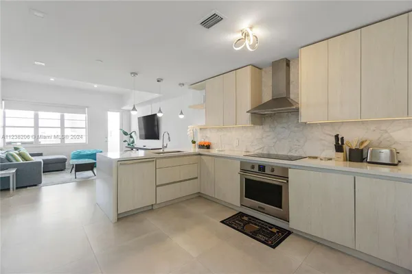 a kitchen with a sink stove top oven and cabinets