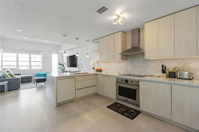 a kitchen with a sink stove top oven and cabinets