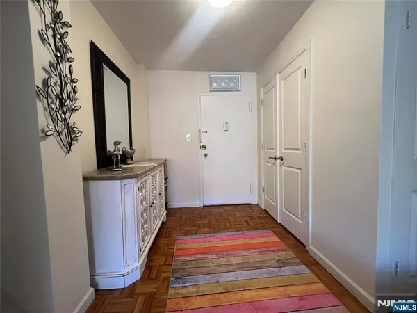 a bedroom with a bed and a view of kitchen