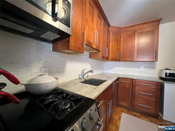 a kitchen with a refrigerator and a sink