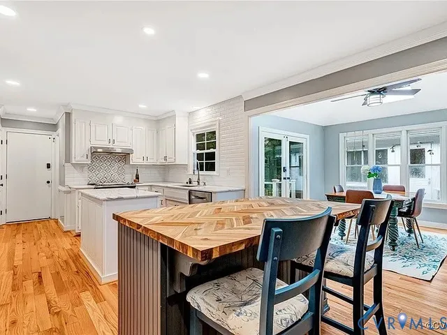 a open kitchen with a table and chairs in it