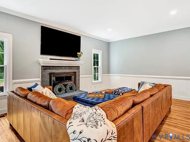 a living room with furniture flat screen tv and a fireplace
