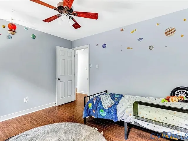 a bedroom with furniture and wooden floor