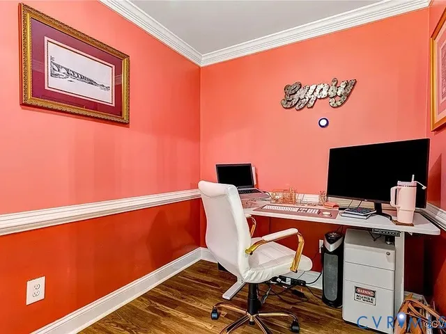 a view of a workspace with furniture and wooden floor