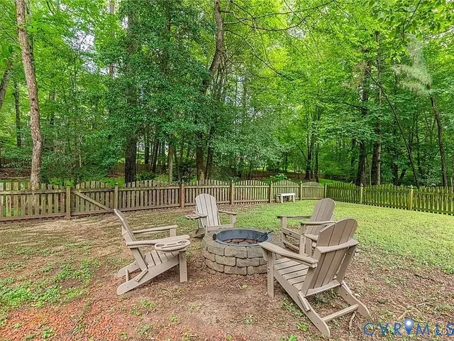 a view of a chair and tables in the backyard