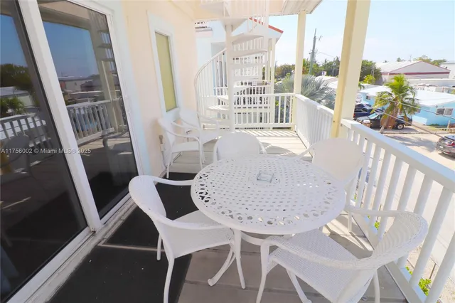 a view of a swimming pool with a table and chairs